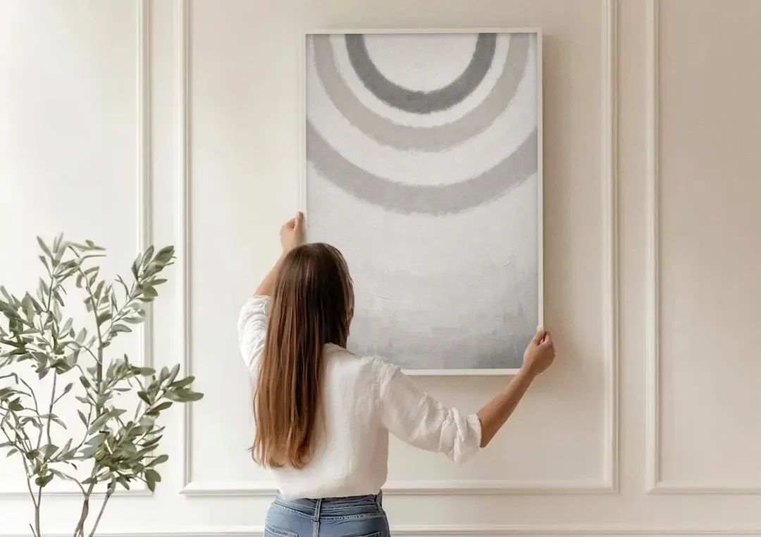 Soft Abstract Painting of Three Grey Ripples canvas wall art being hung on a paneled wall