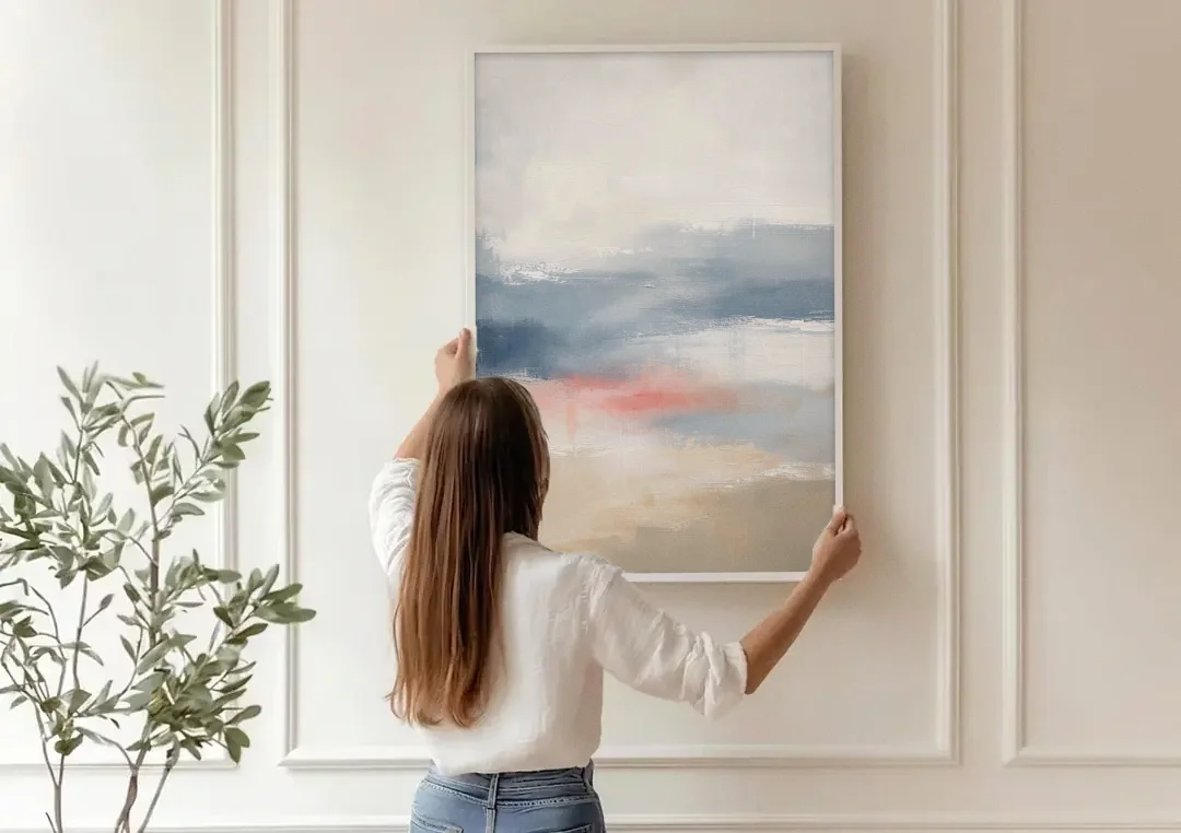 Soft Horizon Bands with a Blush Stroke canvas wall art being hung on a paneled wall