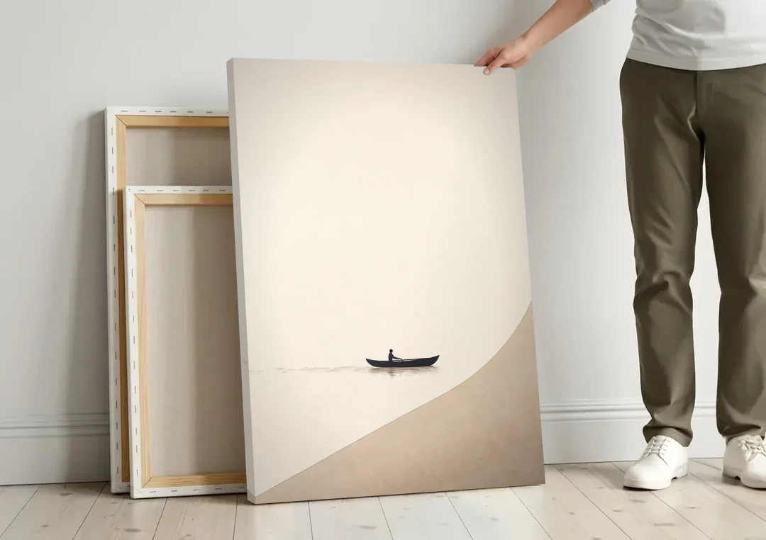 Solitude Painting of a Lone Rower at Dawn canvas wall art leaning against a wall next to blank canvases