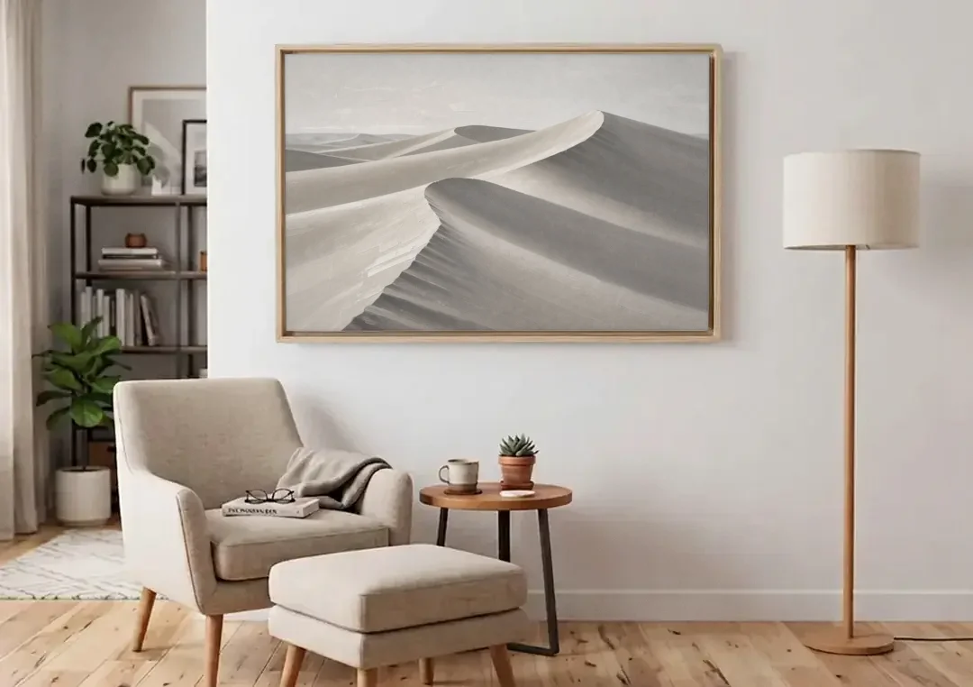 Sophisticated Dune Crests in Ivory and Charcoal canvas wall art above an armchair in a bright living room