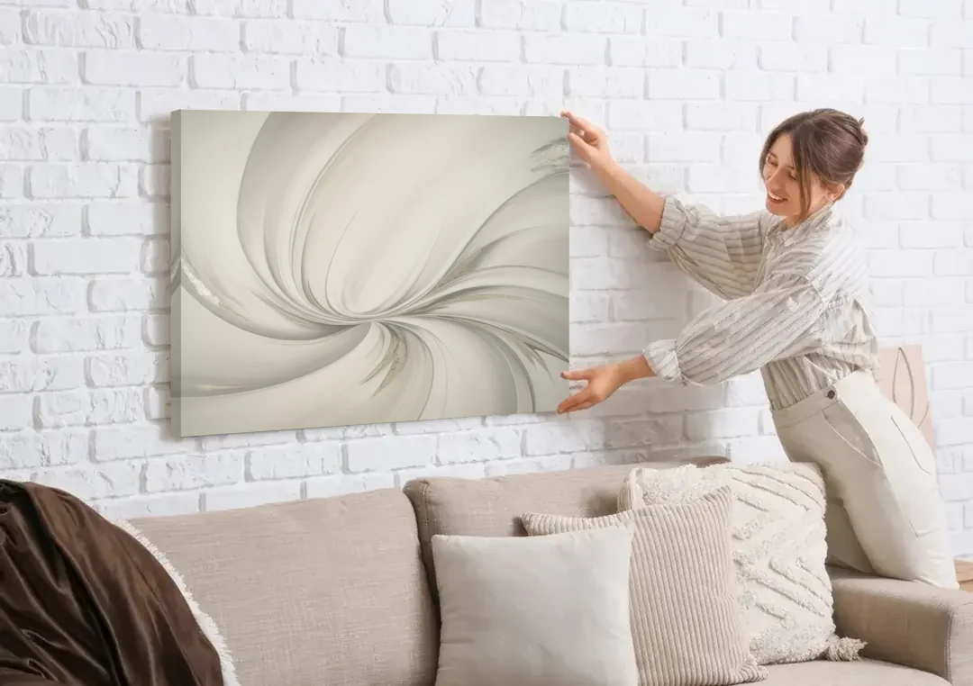 Sophisticated Swirling White Abstract canvas wall art being hung on a white brick wall above a sofa