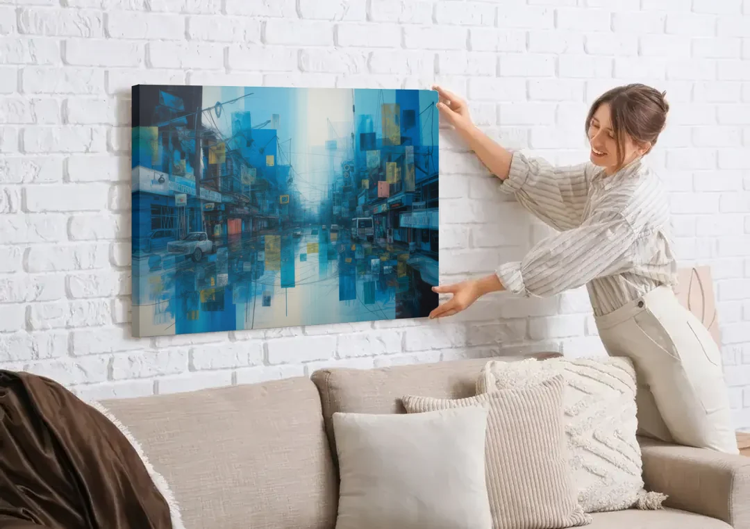 Sophisticated Urban Blue Abstract canvas wall art being hung on a white brick wall above a sofa