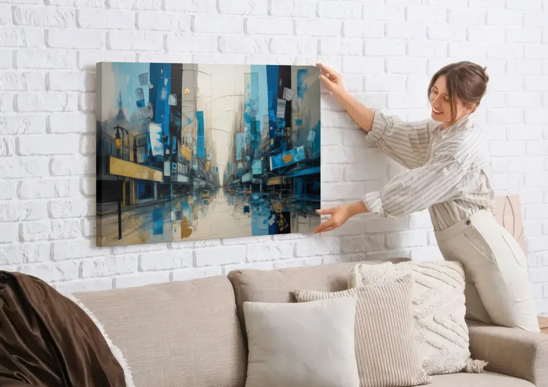 Sophisticated Urban Blue Gold Abstract canvas wall art being hung on a white brick wall above a sofa