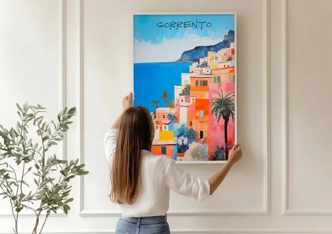 Sorrento Painting of Seaside Houses canvas wall art being hung on a paneled wall