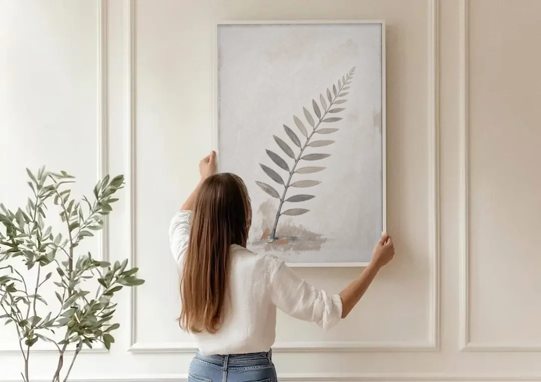 Spa Bathroom Wall Art with a Sword Fern Frond canvas wall art being hung on a paneled wall
