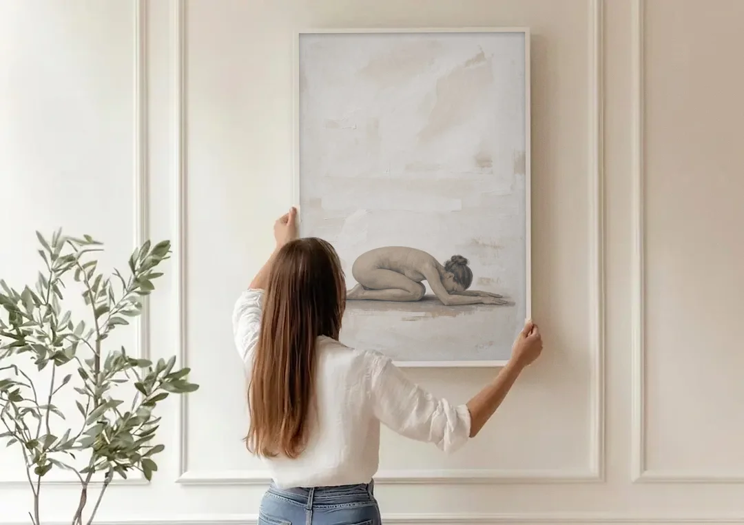 Spa Room Decor with Child's Pose in Sand canvas wall art being hung on a paneled wall