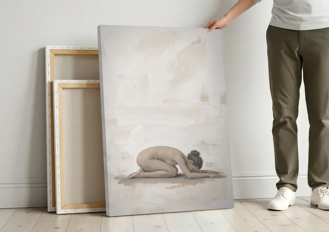 Spa Room Decor with Child's Pose in Sand canvas wall art leaning against a wall next to blank canvases
