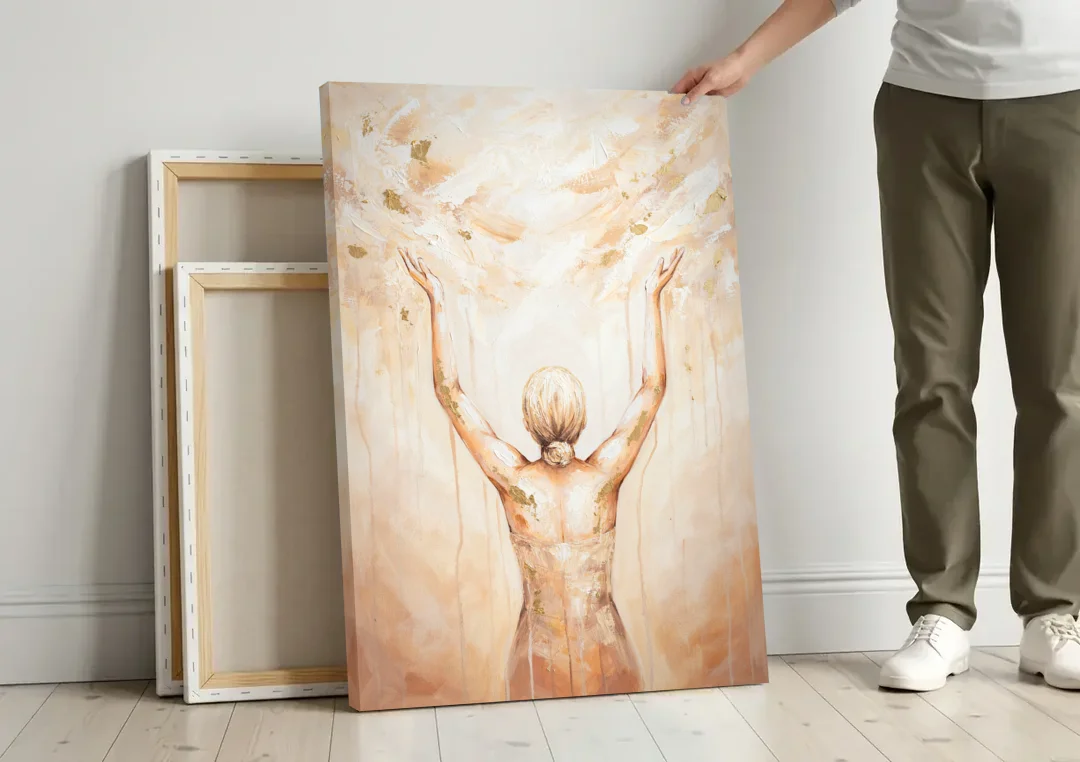 Spiritual Wall Art Sun Salutation in Ivory Light canvas wall art leaning against a wall next to blank canvases