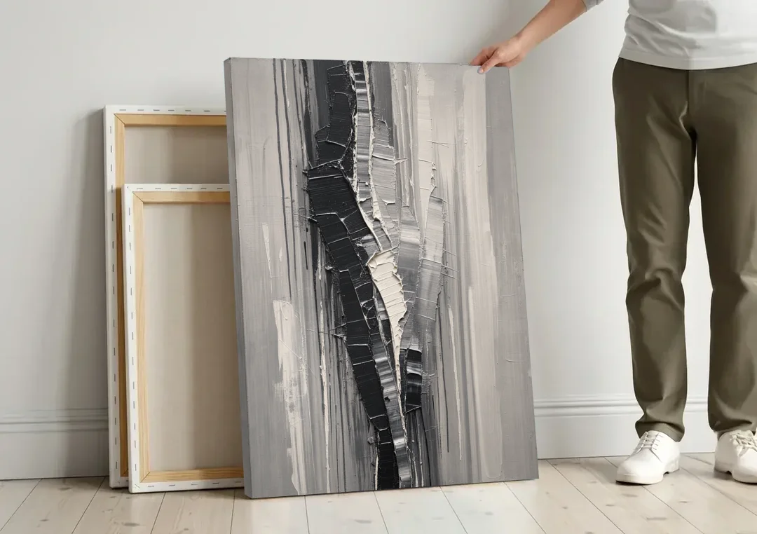 Split Black Column for a Men's Office canvas wall art leaning against a wall next to blank canvases