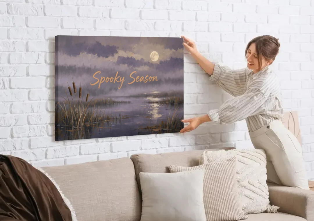 Spooky Halloween Canvas of a Moonlit Marsh canvas wall art being hung on a white brick wall above a sofa