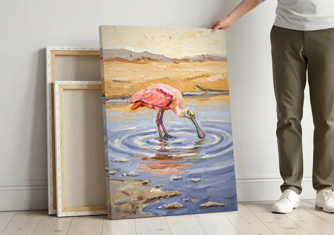 Spoonbill Painting in Golden Shallows canvas wall art leaning against a wall next to blank canvases