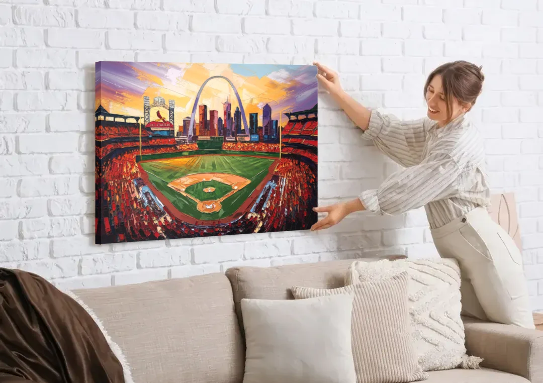 St. Louis Cardinals Busch Stadium canvas wall art being hung on a white brick wall above a sofa