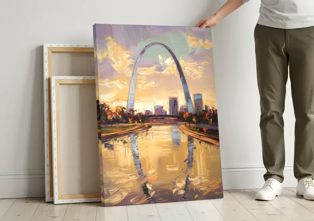 St. Louis Gateway Arch Reflection canvas wall art leaning against a wall next to blank canvases