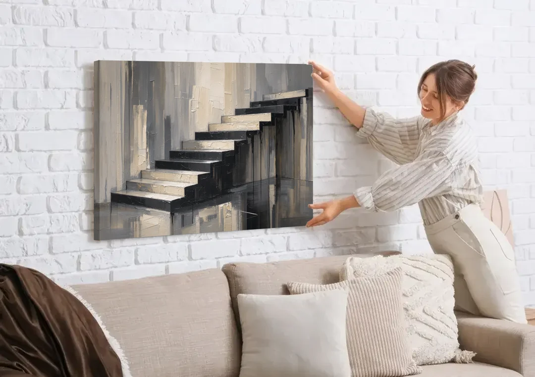 Stairwell Wall Art with Black and Bone Steps canvas wall art being hung on a white brick wall above a sofa