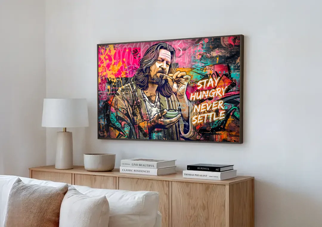 Stay Hungry Never Settle canvas wall art above a wooden sideboard next to a sofa