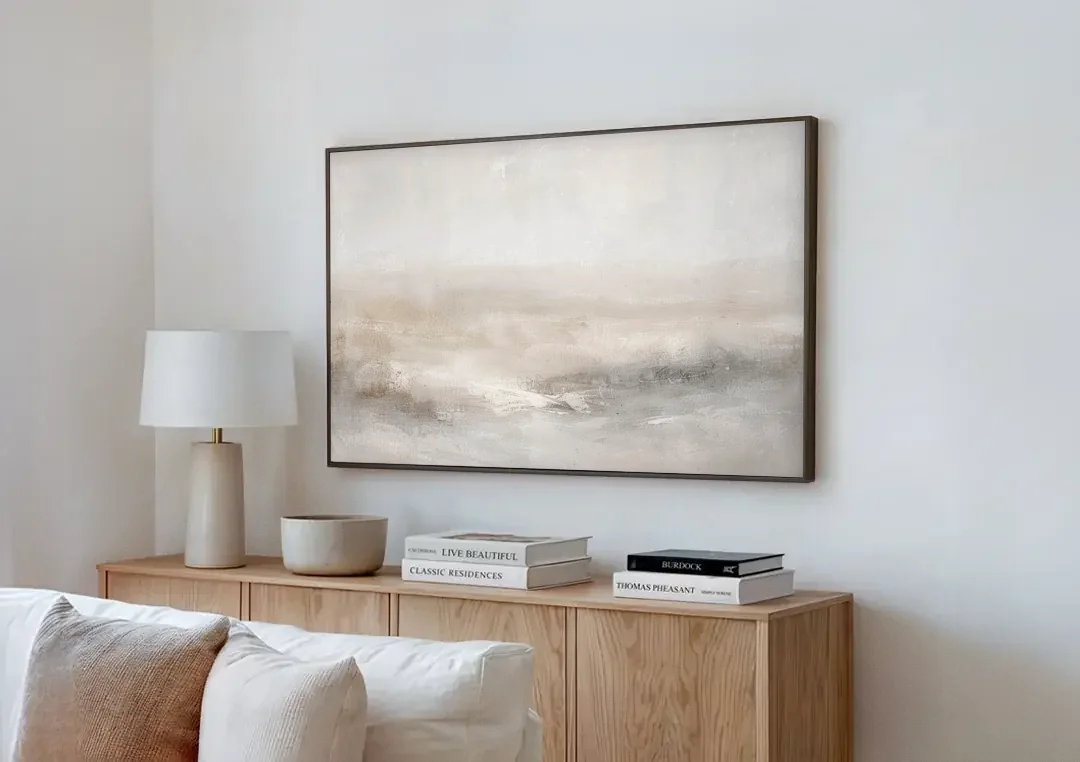 Stillness in Motion canvas wall art above a wooden sideboard next to a sofa