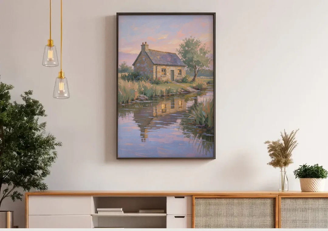 Stone Cottage Painting by the Evening Brook canvas wall art above a wooden sideboard under pendant lights