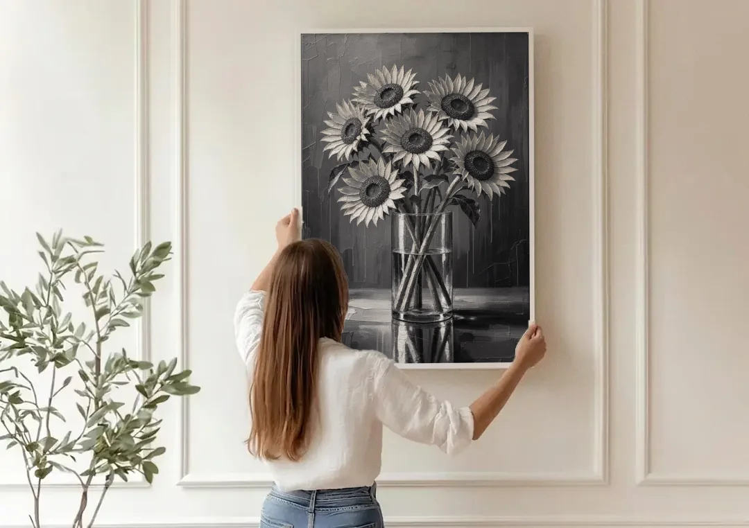 Black and White Sunflower Bouquet in a Glass Vase canvas wall art being hung on a paneled wall