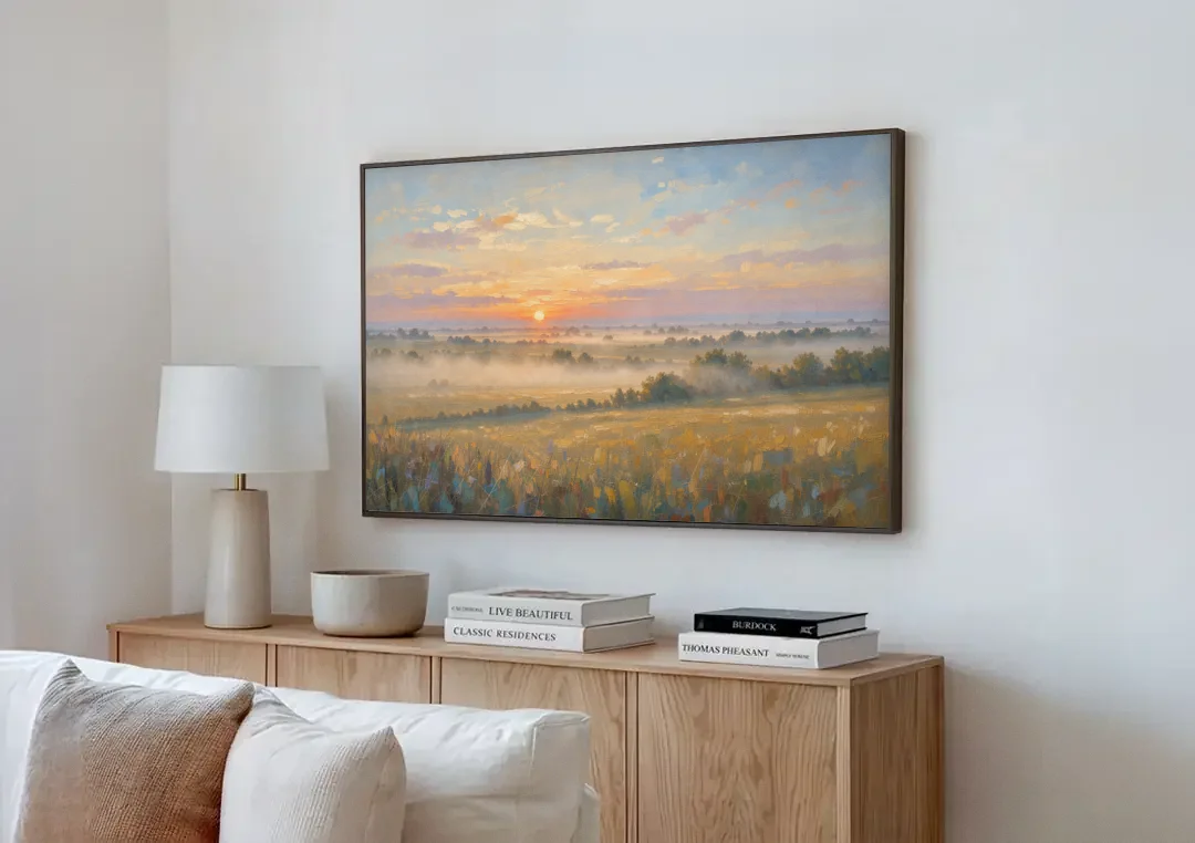Sunrise Landscape Painting Over Misty Farmland canvas wall art above a wooden sideboard next to a sofa