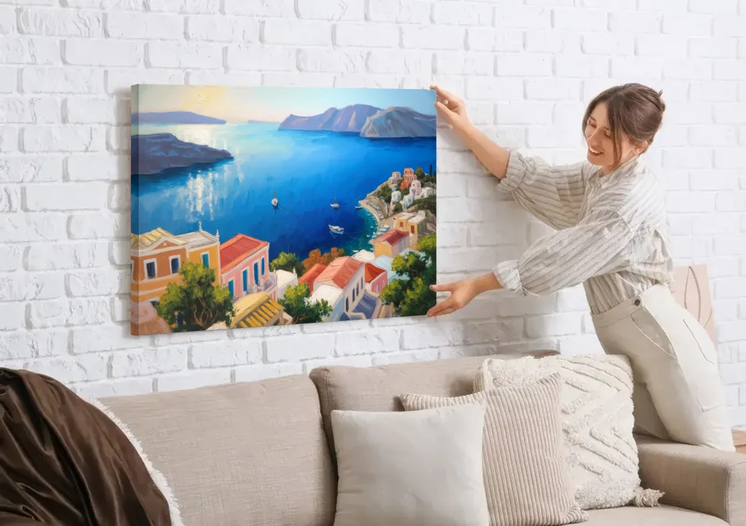 Symi Island Escape canvas wall art being hung on a white brick wall above a sofa