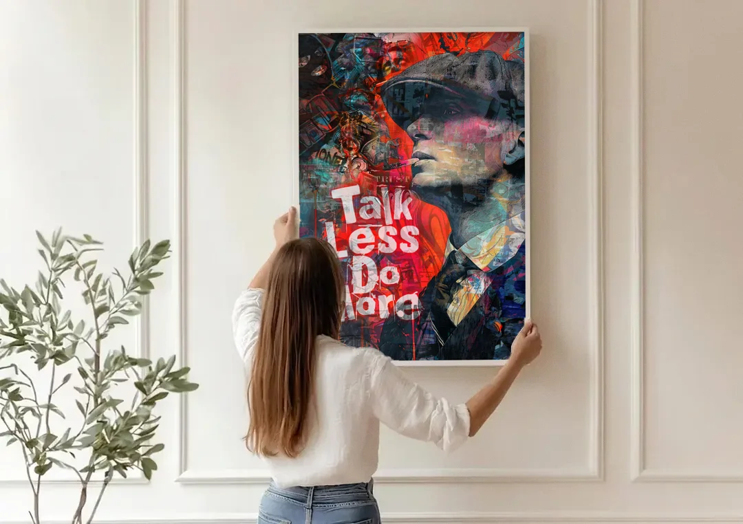 Talk Less Do More canvas wall art being hung on a paneled wall