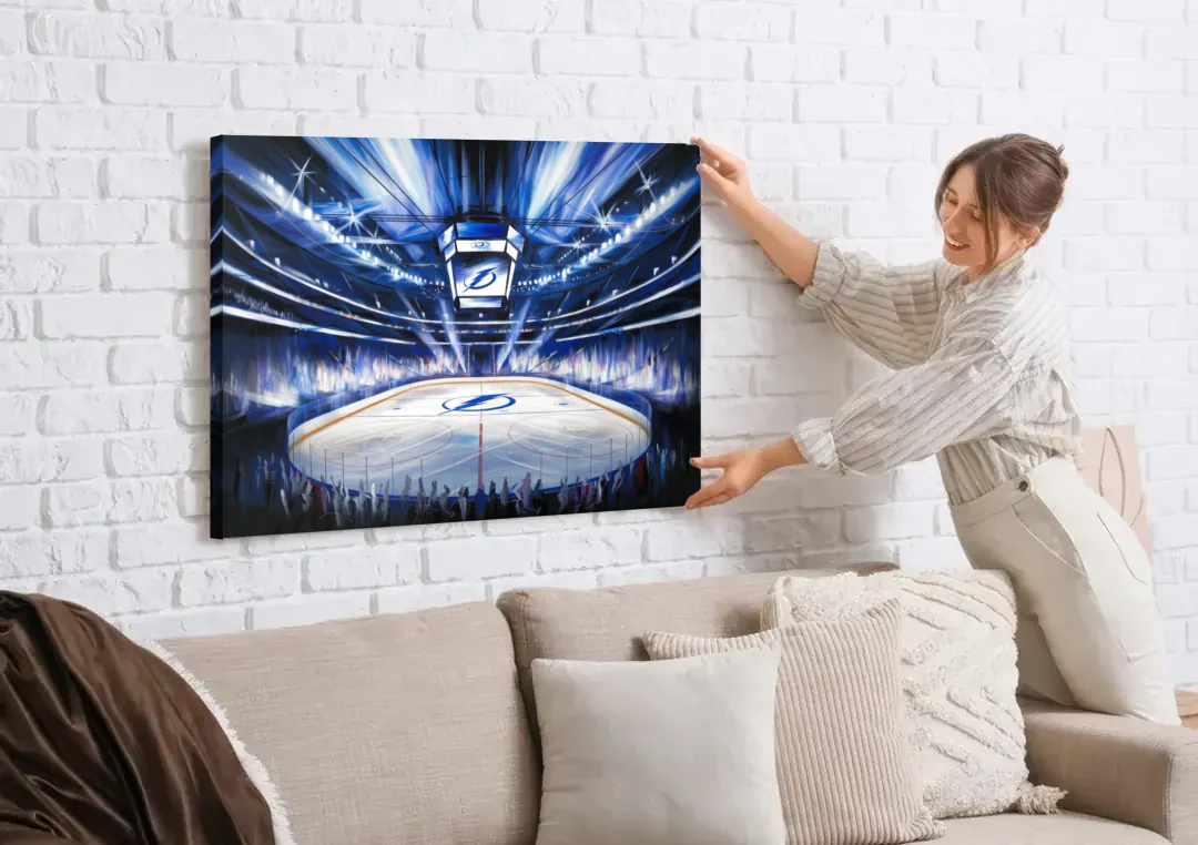 Tampa Bay Lightning Arena Lights canvas wall art being hung on a white brick wall above a sofa