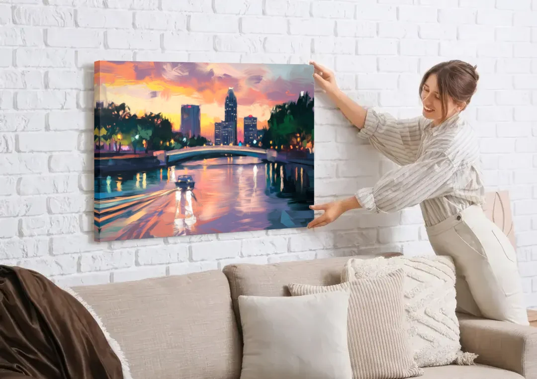 Tampa Riverwalk Evening Glow canvas wall art being hung on a white brick wall above a sofa