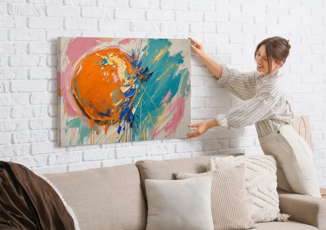 Teal and Orange Wall Art of a Tangerine Collision canvas wall art being hung on a white brick wall above a sofa