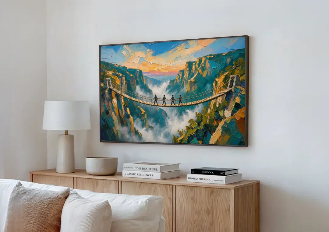 Teamwork Canvas Rope Bridge Over the Misty Gorge canvas wall art above a wooden sideboard next to a sofa