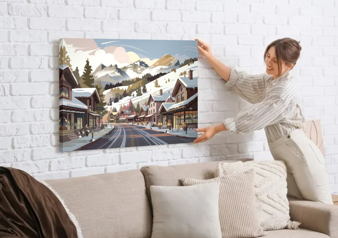 Telluride Ski Village View canvas wall art being hung on a white brick wall above a sofa