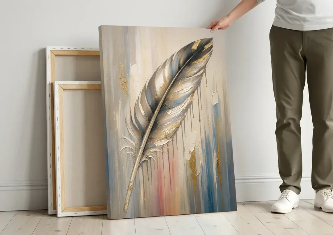 Textured Abstract Greige Gilded Feather canvas wall art leaning against a wall next to blank canvases