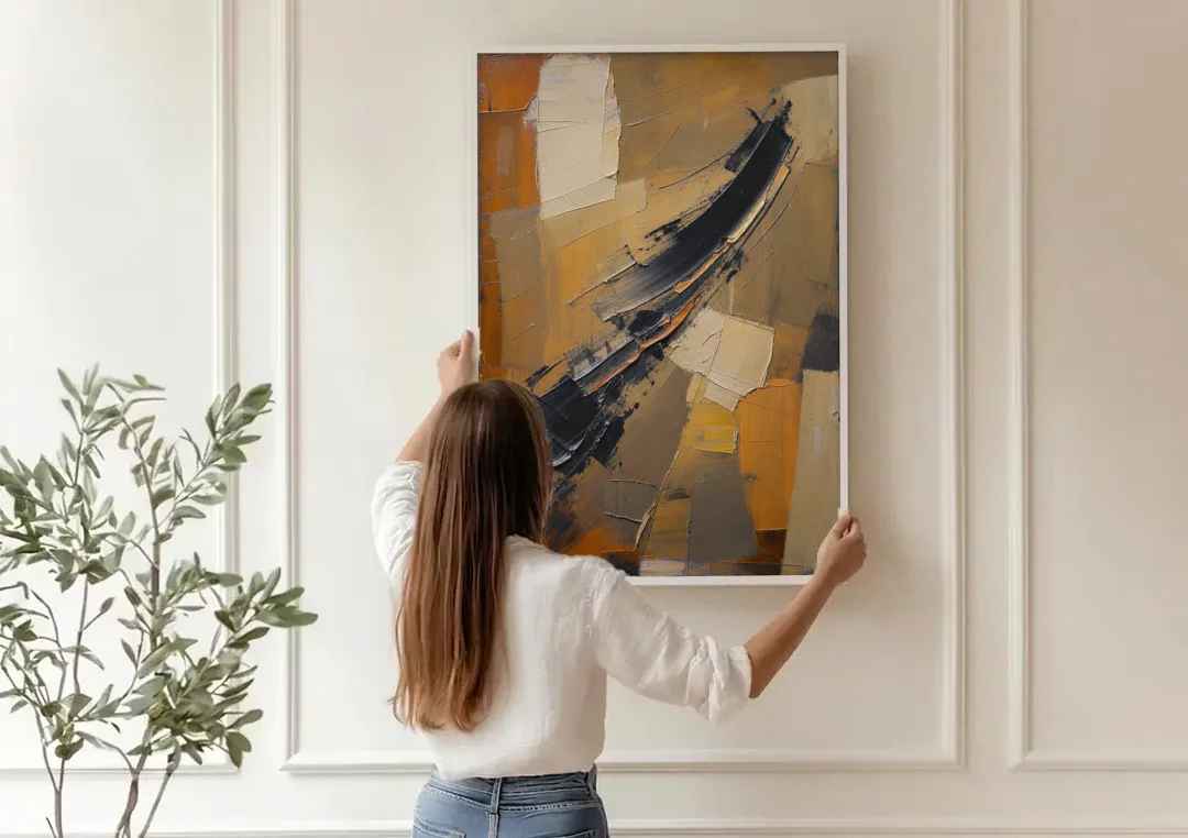 Textured Black Knife Sweep Over Ochre canvas wall art being hung on a paneled wall