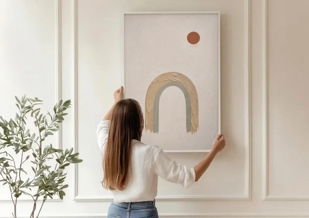 Textured Boho Wall Art with Arch and Rust Sun canvas wall art being hung on a paneled wall