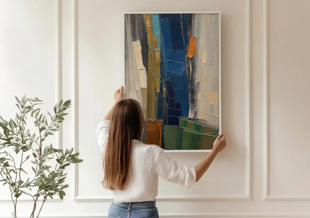 Textured Canvas Painting of Navy and Brass canvas wall art being hung on a paneled wall