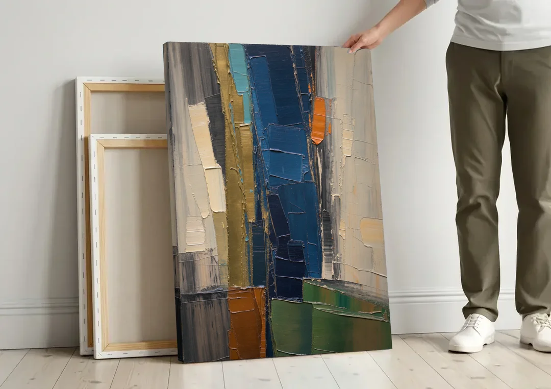 Textured Canvas Painting of Navy and Brass canvas wall art leaning against a wall next to blank canvases