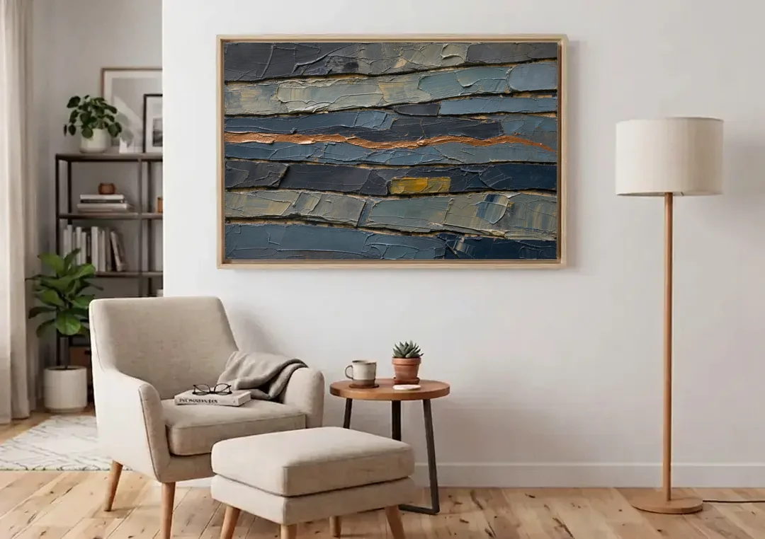 Textured Copper Seam in Basalt canvas wall art above an armchair in a bright living room