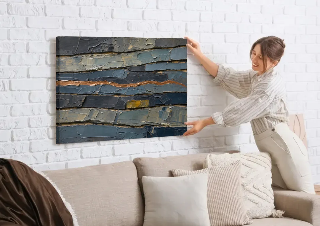 Textured Copper Seam in Basalt canvas wall art being hung on a white brick wall above a sofa