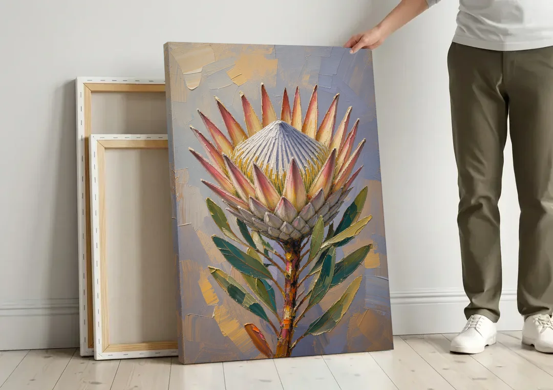 Textured Floral Wall Art of a King Protea canvas wall art leaning against a wall next to blank canvases