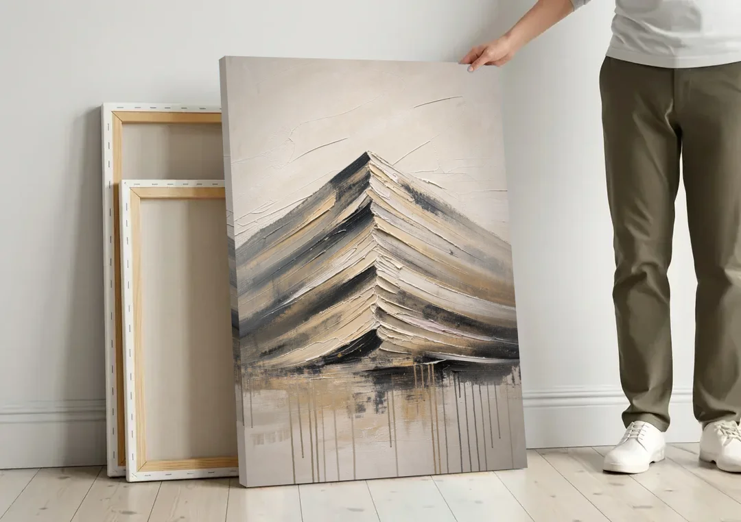 Textured Mountain Painting with Dripping Base canvas wall art leaning against a wall next to blank canvases