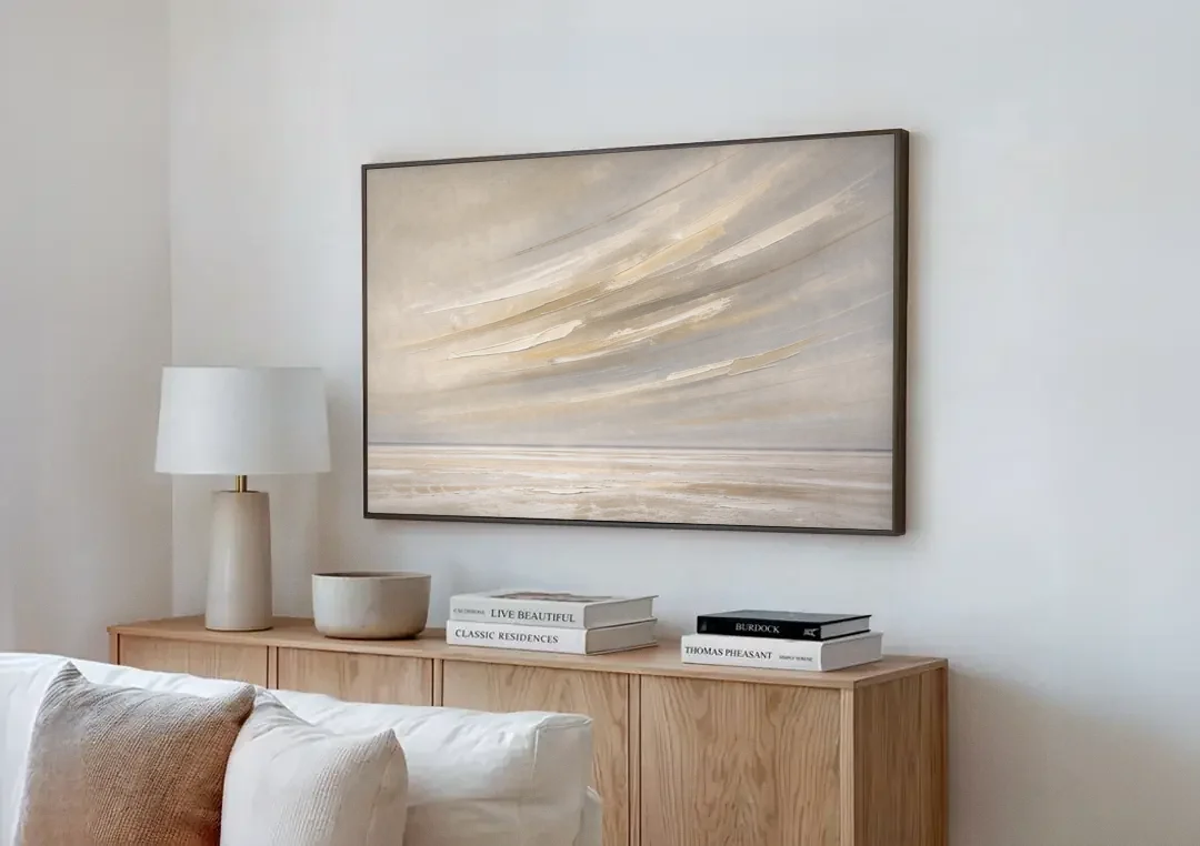 Textured Neutral Wall Art of Wind Streaks Over Flats canvas wall art above a wooden sideboard next to a sofa