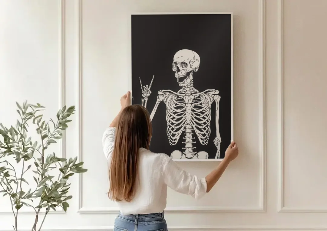 The Fun Halloween Skeleton canvas wall art being hung on a paneled wall