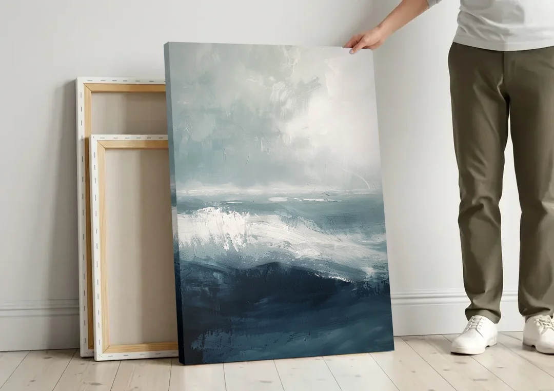 The Wave Breathes canvas wall art leaning against a wall next to blank canvases