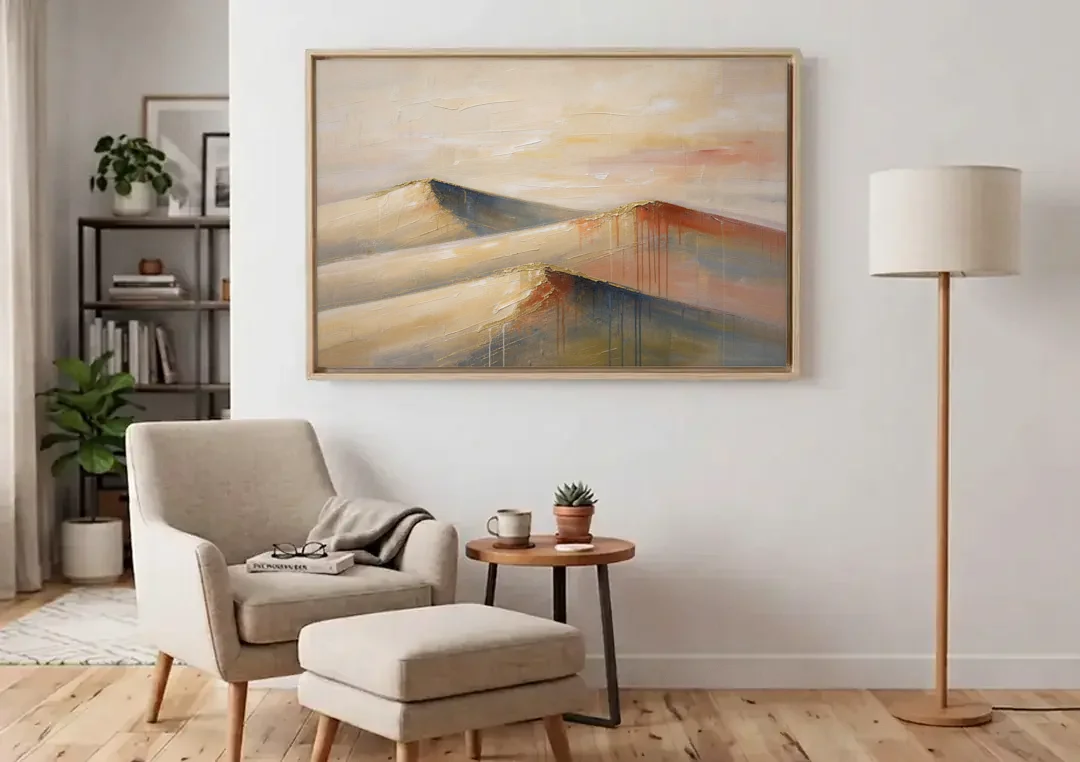 Three Abstract Terracotta Dune Crests canvas wall art above an armchair in a bright living room