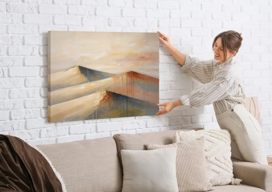 Three Abstract Terracotta Dune Crests canvas wall art being hung on a white brick wall above a sofa