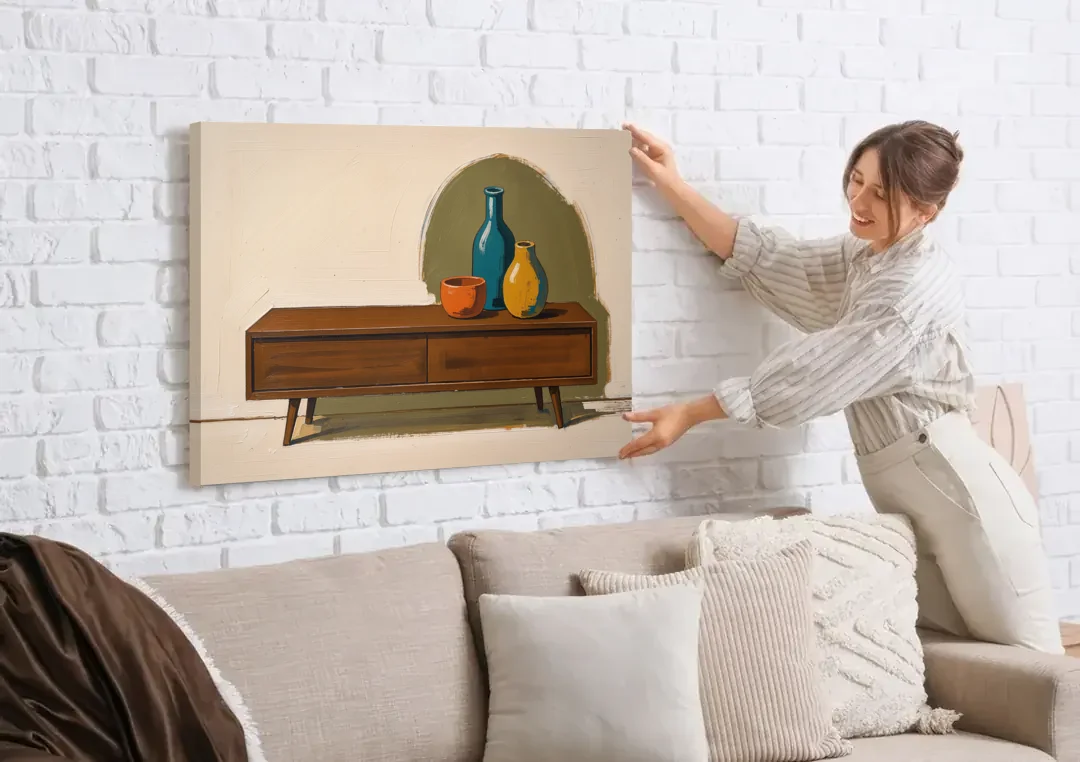 Three Ceramic Vases on a Walnut Sideboard canvas wall art being hung on a white brick wall above a sofa