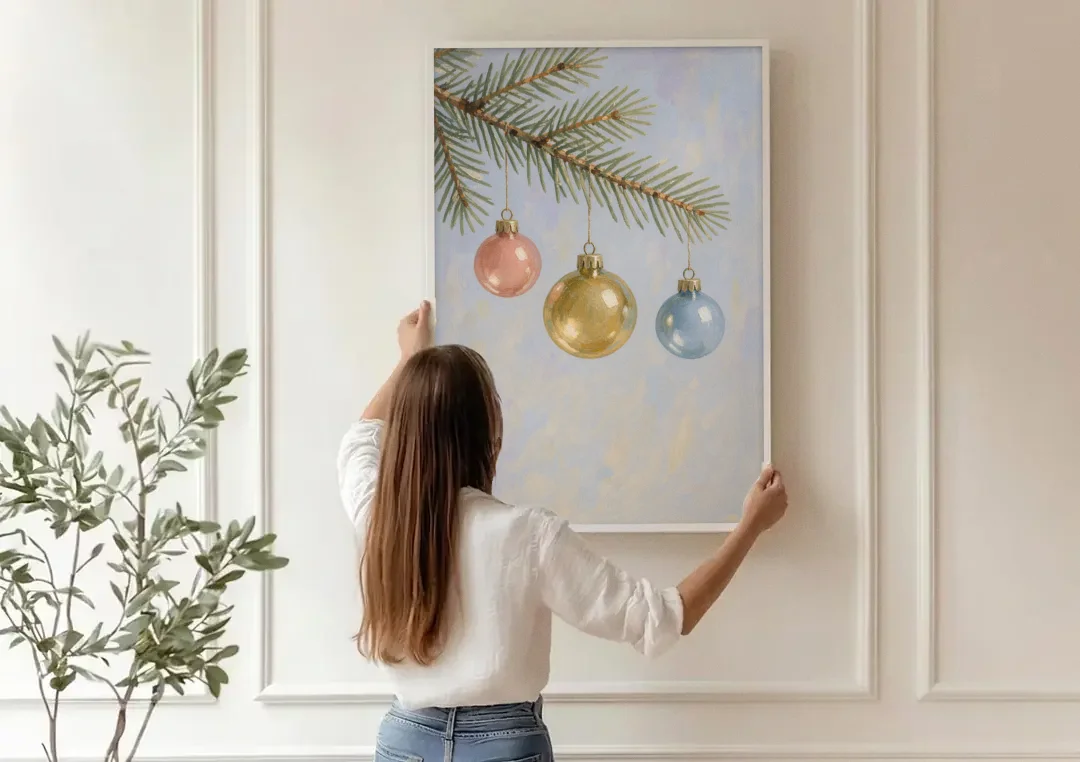 Three Glass Baubles on a Fir Branch canvas wall art being hung on a paneled wall