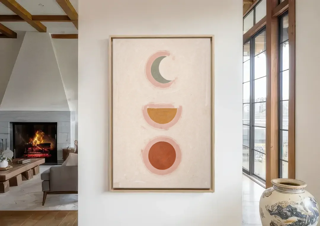 Three Moon Phases Stacked in Earth Tones canvas wall art in a living room with a fireplace