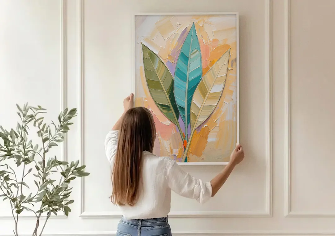 Three Neutral Textured Leaves in Sage and Teal canvas wall art being hung on a paneled wall
