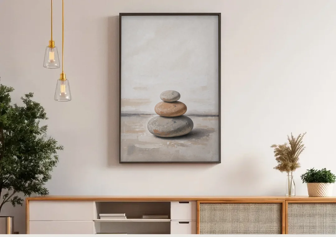 Three Stacked Stones on Pale Dusk Ground canvas wall art above a wooden sideboard under pendant lights