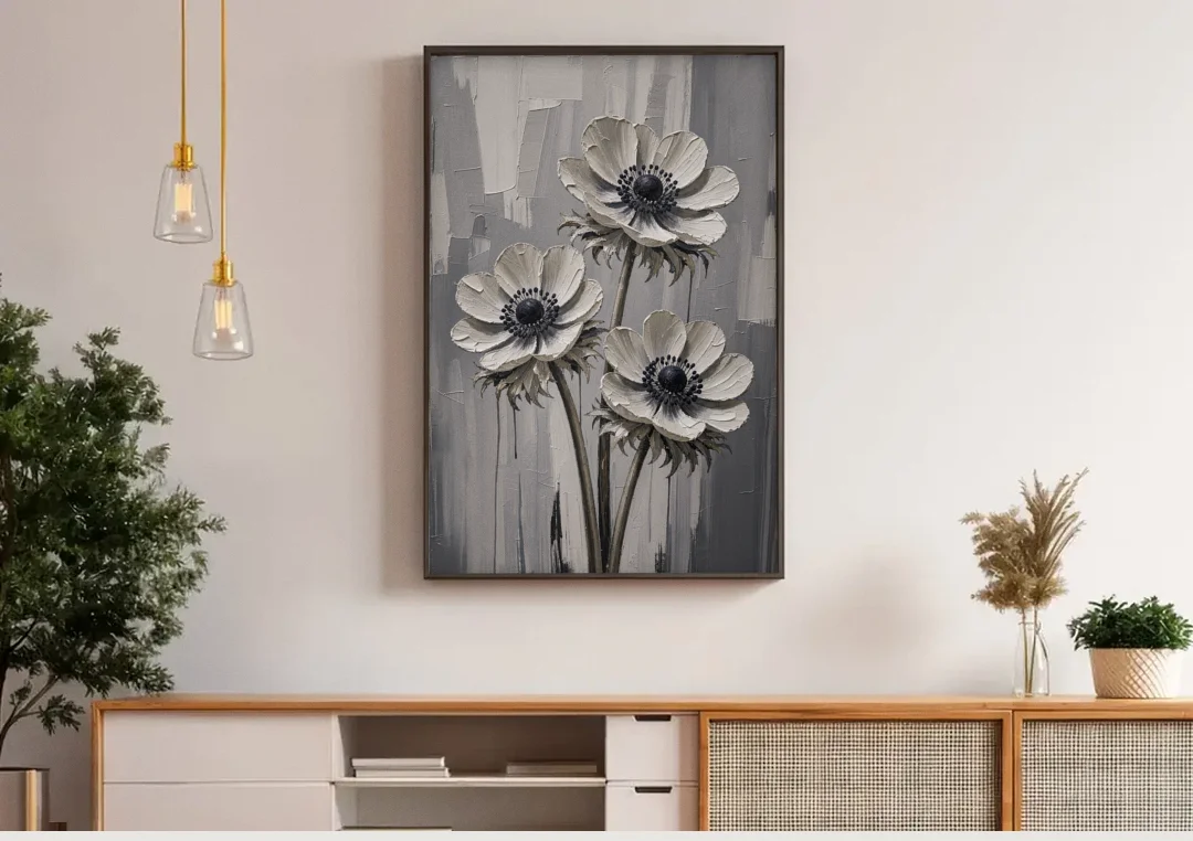 Three White Anemones with Black Centers canvas wall art above a wooden sideboard under pendant lights